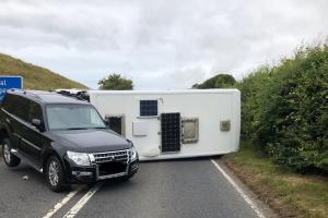 A35 closed after caravan overturns